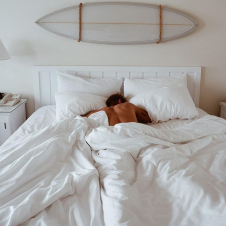 Man in Laguna Beach House bed