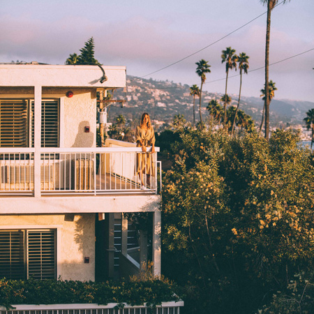 Woman standing on a balcony at Laguna Beach House