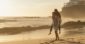 Woman being carried on the beach