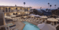 Poolside lounge at Laguna Beach House with ocean views at sunset.